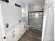 Modern bathroom with double vanity, shower, and white cabinets at 9605 Hwy 52 N None # 4, Wadesboro, NC 28170