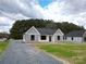 Newly constructed home with gray and white siding, gravel driveway and landscaping at 9605 Hwy 52 N None # 4, Wadesboro, NC 28170