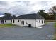 Back of the house with double doors, AC unit, and gravel driveway at 9605 Hwy 52 N None # 4, Wadesboro, NC 28170