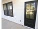 House side view, featuring a black door, windows, and exterior lighting at 9605 Hwy 52 N None # 4, Wadesboro, NC 28170