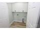 Small laundry room with white cabinets and vinyl flooring at 9617 Hwy 52 N None # 3, Wadesboro, NC 28170