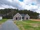 Gray vinyl-sided house with a gray roof, covered porch, and gravel driveway at 9617 Hwy 52 N None # 3, Wadesboro, NC 28170