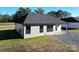 Side view of a gray house with a covered patio and gravel driveway at 9617 Hwy 52 N None # 3, Wadesboro, NC 28170