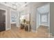Light and airy hallway with hardwood floors and art at 130 Cherokee Rd # 102, Charlotte, NC 28207