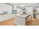 Modern kitchen with white cabinets, light blue backsplash, and island at 130 Cherokee Rd # 102, Charlotte, NC 28207