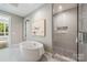 Relaxing bathroom with a modern freestanding tub and a glass-enclosed shower at 130 Cherokee Rd # 102, Charlotte, NC 28207