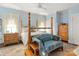Cozy bedroom with a four-poster bed and sitting area at 205 Vauxhall Dr, Shelby, NC 28150