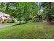 Large backyard with a wooden playset and slide at 205 Vauxhall Dr, Shelby, NC 28150