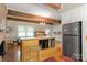 Open kitchen with island, stainless steel refrigerator, and hardwood floors at 205 Vauxhall Dr, Shelby, NC 28150