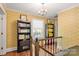 Upper hallway with built-in bookshelves and hardwood floors at 205 Vauxhall Dr, Shelby, NC 28150
