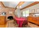 Spacious dining room featuring a brick fireplace and hardwood floors at 205 Vauxhall Dr, Shelby, NC 28150
