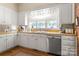 Bright kitchen with white cabinets, butcher block counters, and stainless steel appliances at 205 Vauxhall Dr, Shelby, NC 28150