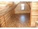 Spacious attic room with wood paneling and wood-look flooring at 710 Austin St # 124, Albemarle, NC 28001