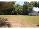Spacious backyard with grassy area and a white shed at 710 Austin St # 124, Albemarle, NC 28001