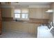 Galley kitchen with light cabinets, and vinyl flooring at 710 Austin St # 124, Albemarle, NC 28001