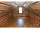 Bright attic room featuring wood walls and flooring at 710 Austin St # 124, Albemarle, NC 28001