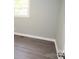 Light-grey walls, grey flooring and a window in this well-lit bedroom at 412 Lakeview Dr, Wadesboro, NC 28170