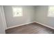 Well-lit bedroom featuring grey flooring, light walls, and multiple windows at 412 Lakeview Dr, Wadesboro, NC 28170