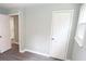 Bedroom with grey flooring, light walls, and doors to bathroom and closet at 412 Lakeview Dr, Wadesboro, NC 28170