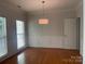 Formal dining room with hardwood floors, wainscoting, and a modern light fixture at 137 Kilborne Rd, Mooresville, NC 28117