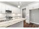 Modern kitchen features granite island, white cabinets, and stainless steel appliances at 121 Arboretum Way, Shelby, NC 28152