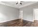 Bedroom with hardwood floors, ceiling fan, and access to bathroom at 121 Arboretum Way, Shelby, NC 28152
