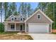 Modern farmhouse style home with white garage door and front porch at 121 Arboretum Way, Shelby, NC 28152