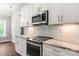 White shaker cabinets, granite countertops, and stainless steel appliances in kitchen at 121 Arboretum Way, Shelby, NC 28152