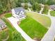 Aerial view of a white farmhouse with a large green lawn and paved driveway at 7362 Hemlock Ct, Denver, NC 28037