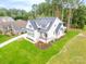 Aerial view of a white farmhouse with a gray roof and green lawn at 7362 Hemlock Ct, Denver, NC 28037