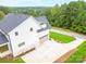 Aerial view of a white farmhouse with a gray garage and driveway at 7362 Hemlock Ct, Denver, NC 28037