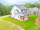 Aerial view of a two-story white farmhouse with a deck and backyard at 7362 Hemlock Ct, Denver, NC 28037