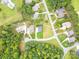 Aerial view of homes and lot in a wooded community at 7362 Hemlock Ct, Denver, NC 28037