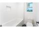 Clean bathroom with white subway tile and bathtub at 7362 Hemlock Ct, Denver, NC 28037