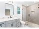 Modern bathroom with gray tile shower, quartz vanity, and frameless glass at 7362 Hemlock Ct, Denver, NC 28037