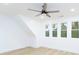 Charming bedroom with sloped ceilings, light hardwood floors and three windows at 7362 Hemlock Ct, Denver, NC 28037