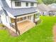 Covered deck with wooden flooring and metal railings, overlooking backyard at 7362 Hemlock Ct, Denver, NC 28037