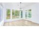Light-filled dining area with hardwood floors, french doors, and a chandelier at 7362 Hemlock Ct, Denver, NC 28037