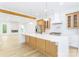 Modern kitchen with island, white quartz countertops, and wood cabinets at 7362 Hemlock Ct, Denver, NC 28037