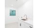 Bright laundry room with white cabinets and patterned floor at 7362 Hemlock Ct, Denver, NC 28037