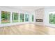 Living room with wall-to-wall windows, fireplace and hardwood floors at 7362 Hemlock Ct, Denver, NC 28037