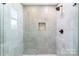 Modern shower with glass enclosure and pebble accents at 7362 Hemlock Ct, Denver, NC 28037