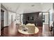 Spacious sitting area featuring two armchairs, a round ottoman, and hardwood floors at 139 S Tryon St # 6, Charlotte, NC 28202