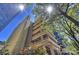 Building exterior showcasing architectural details and city backdrop at 139 S Tryon St # 6, Charlotte, NC 28202