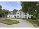 Beautiful two-story home with circular driveway, manicured lawn at 18612 Balmore Pines Ln, Cornelius, NC 28031