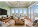 Relaxing sunroom with a comfortable sofa and access to outdoor views at 590-0 Tuckertown Rd, New London, NC 28127