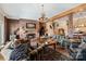 Living room with brick fireplace, antler chandelier, and comfortable plaid sofas at 590-0 Tuckertown Rd, New London, NC 28127