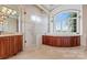Luxurious bathroom with soaking tub, walk-in shower, and large window at 590-0 Tuckertown Rd, New London, NC 28127