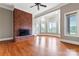 Spacious living room with brick fireplace and hardwood floors at 590-0 Tuckertown Rd, New London, NC 28127