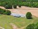 Aerial view of a house and large barn situated on a wide plot of land at 4809 Us 74 Hwy, Wingate, NC 28174